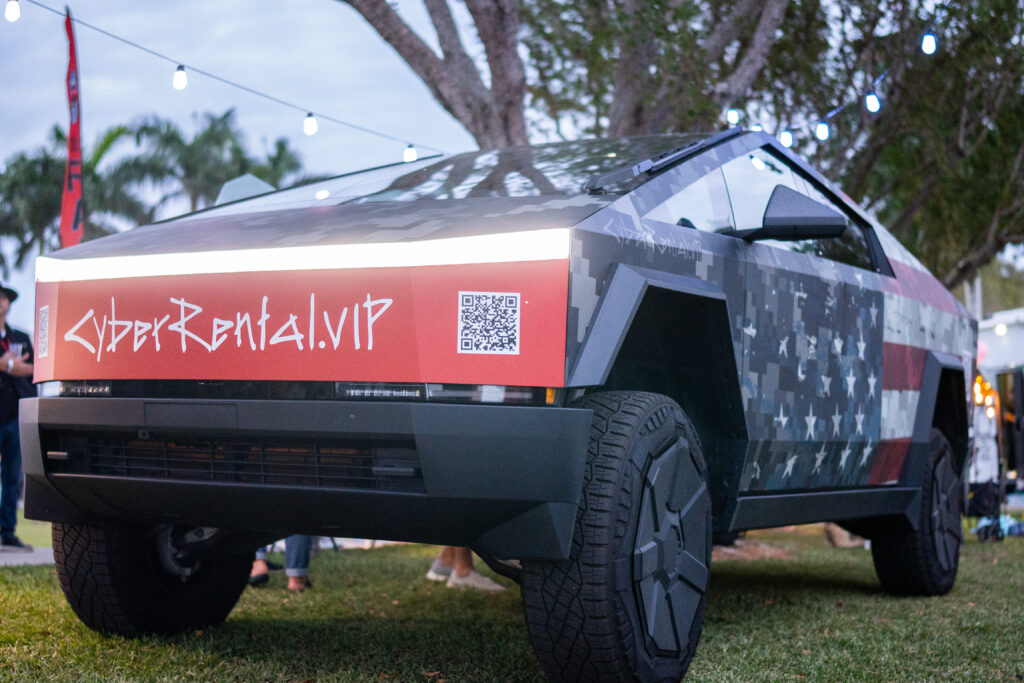Front view of a Cybertruck with CyberRental.VIP branding at a South Florida outdoor showcase.